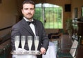 Professional waiter serving champagne wine glasses Royalty Free Stock Photo