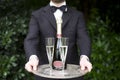 Professional waiter serving champagne wine glasses Royalty Free Stock Photo