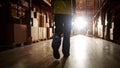 Professional Warehouse Worker Wearing Safety West Walking Through The Strorage Facility, Distribut
