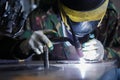 Professional welder in protective mask welding with electric torch Royalty Free Stock Photo