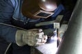 Professional welder welding metal parts