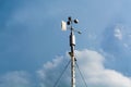 Meteorological Insights: Professional Weather Vane under Dramatic Blue Sky