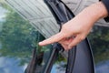 Professional windshield man repairman pointed a crack in car glass