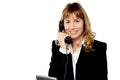 Professional woman answering phone call Royalty Free Stock Photo