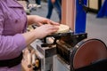 Professional woman carpenter hands using belt sander machine