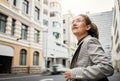 Professional woman in city, travel and commute to work with buildings, motion blur and waiting for taxi cab. Corporate Royalty Free Stock Photo