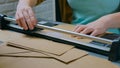 Woman using paper cutter, guillotine, designer working Royalty Free Stock Photo