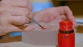 Professional woman decorator preparing paint for work