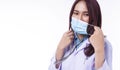 Professional woman doctor in uniform white clothes with stethoscope while wearing medical mask protection from inhaling Royalty Free Stock Photo