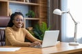 Professional woman in glasses with dreadlocks freelances from home