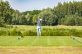 Professional woman golfer wearing golf wear teeing golf in golf tournament competition at golf course for winner.