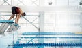Professional woman swimmer in a starting position in the pool Royalty Free Stock Photo