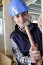 Professional woman using hammer and nail Royalty Free Stock Photo