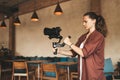 Professional woman videographer with gimball video slr