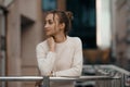 Professional woman worker wear standing outdoor terrace with a smile leaning on railing enjoy view from modern office Royalty Free Stock Photo