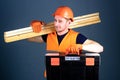Professional woodworker concept. Carpenter, labourer, builder, woodworker on smiling face carries wooden beams on