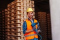 Professional woodworker in hardhat holding pneumatic hammer