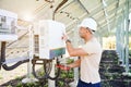 Professional worker checking voltage on solar inverter. Royalty Free Stock Photo