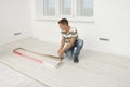 Professional worker installing new laminate flooring indoors Royalty Free Stock Photo