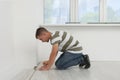 Professional worker installing new laminate flooring indoors Royalty Free Stock Photo