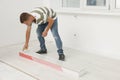 Professional worker installing new laminate flooring indoors Royalty Free Stock Photo