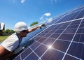 Professional worker installing solar panels on the green metal construction