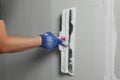 Professional worker plastering wall with putty knife, closeup Royalty Free Stock Photo