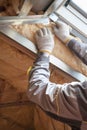 Professional worker putting mineral rockwool insulation in wall