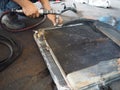 Professional worker repairing radiator cooling of car in garage workshop