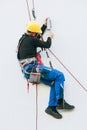 Professional worker repairs a light on the building Royalty Free Stock Photo