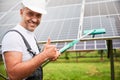 Professional worker showing his good job of cleaning solar panel. Royalty Free Stock Photo