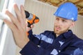 professional worker using drill on pvc window Royalty Free Stock Photo