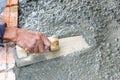 Professional worker using trowel for building cement floor. Royalty Free Stock Photo