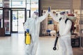 Workers in hazmat suits disinfecting indoor of mall, pandemic health risk, coronavirus