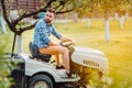 Professional working man, gardener using a lawn mower Royalty Free Stock Photo