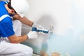 Professional Workman Applying Silicone Sealant With Caulking Gun