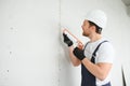 Professional Workman Applying Silicone Sealant With Caulking Gun on the Wall