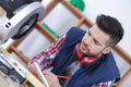 Professional workman cutting wooden planks using circular saw in workshop