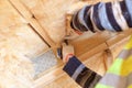 Professional workman using knife tool, cutting rockwool