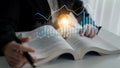Business analysis with light bulb concept, charts, and graphs over open book for creativity, learning, innovation, and Royalty Free Stock Photo