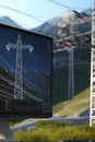 Professional workstation showing a CAD design of high-voltage power lines crossing a mountainous region.