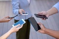 The professional world is never out of reach. a group of business people holding an array of smartphones.