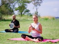 A group of four holds yoga classes in the park. Healthy lifestyle. Royalty Free Stock Photo