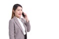 Professional young Asian business woman in formal suit with white shirt is use smartphone to calling telephone to check data while Royalty Free Stock Photo