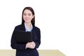 Professional young Asian business woman office worker in black suit holds clipboard in her hands and confident smiles in office Royalty Free Stock Photo