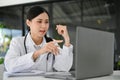 Professional Asian female doctor working in the office, using laptop computer Royalty Free Stock Photo