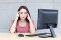 Professional young  Asian professional business woman who wears pink dress is working tired and feeling headache while she works. Royalty Free Stock Photo