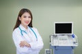 Professional young Asian woman doctor wearing white robe standing with arms crossed. Wearing a white robe and stethoscope happy Royalty Free Stock Photo