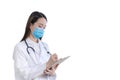 Professional young Asian woman doctor wearing white robe standing with work and look at the report of patient in hospital while Royalty Free Stock Photo