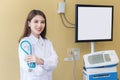 Professional young Asian woman doctor wearing white robe and stethoscope standing with arms crossed happy and smile at examination Royalty Free Stock Photo